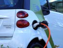 Electric car connected with a charging station.