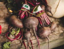 Beets in a bunch lying on a table.