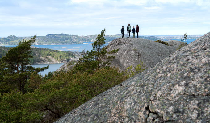 Family hiking on rocks.
